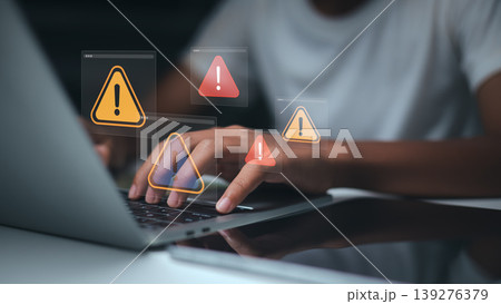 Cyber security warning on laptop screen,System error notification while working,Data breach alert digital icon overlays,Online fraud protection concept for business,Remote worker experiencing attack 139276379