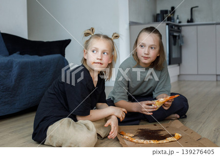 Happy friends girl and boy eating pizza at home 139276405