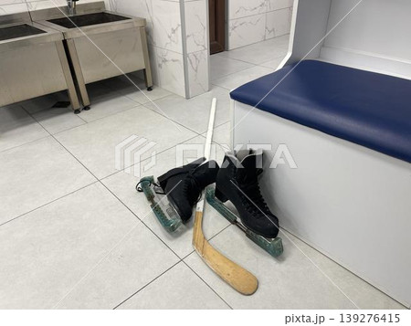 sportswear and skates for a hockey player in the team's locker room sportswear and skates for a hockey player in the team's locker room 139276415
