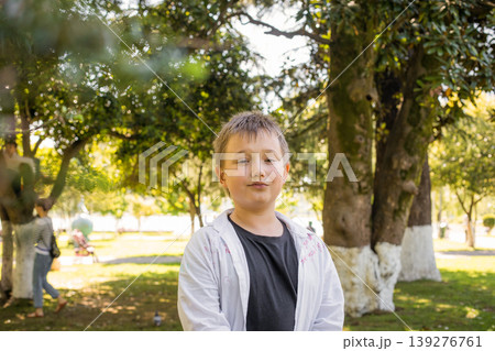 Playful child boy in park outdoors Playful child boy in park outdoors 139276761