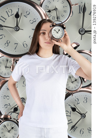 Woman experiencing time pressure with multiple alarm clocks Woman experiencing time pressure with multiple alarm clocks 139276919