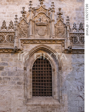 Ornate Gothic Stone Window With Coat of Arms and Intricate Carvings on Historic Royal Chapel of Granada Ornate Gothic Stone Window With Coat of Arms and Intricate Carvings on Historic Royal Chapel of Granada 139277190