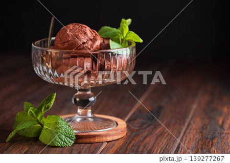 Chocolate Ice Cream with Mint Leaves on Dark Wooden Background Chocolate Ice Cream with Mint Leaves on Dark Wooden Background 139277267