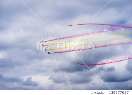 Group of airplanes performs stunts in the air and releases colored smoke Group of airplanes performs stunts in the air and releases colored smoke 139277627