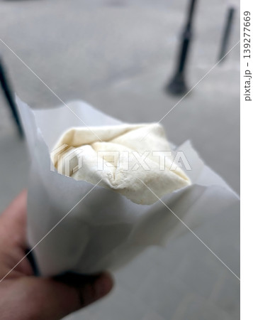 Delicious Doner Kebab Wrapped in Paper Held by a Person on a City Street Delicious Doner Kebab Wrapped in Paper Held by a Person on a City Street 139277669
