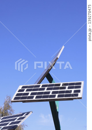 Photovoltaic solar panels generating sustainable clean energy under clear blue sky Photovoltaic solar panels generating sustainable clean energy under clear blue sky 139278475