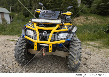 Powerful all terrain vehicle parked on a gravel path in a natural outdoor setting Powerful all terrain vehicle parked on a gravel path in a natural outdoor setting 139278549