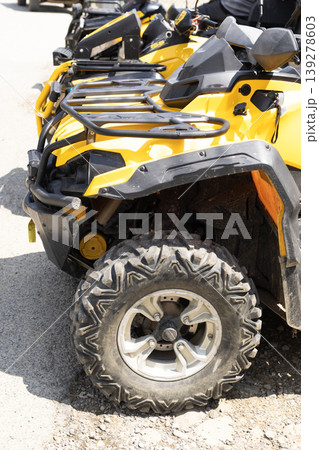 Bright yellow offroad quad bike parked on gravel ready for adventure journey 139278603