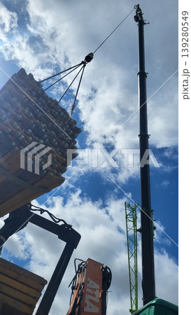 Crane lifting a concrete bucket for foundation pouring, industrial building engineering, professional site work 139280549