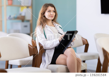 Young woman medical student takes notes on tablet Young woman medical student takes notes on tablet 139281584