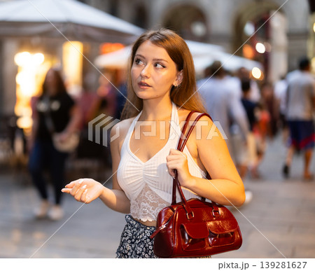 Woman walking around Barcelona, she has visited Placa real and plans to spend the evening in bars and restaurants with friends Woman walking around Barcelona, she has visited Placa real and plans to spend the evening in bars and restaurants with friends 139281627