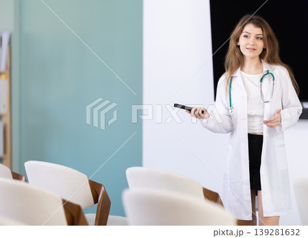 Female doctor standing with controller and making presentation 139281632