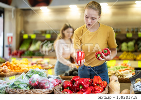 Young woman choosing peppers in the store Young woman choosing peppers in the store 139281719