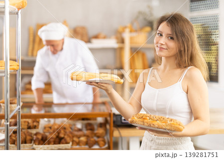 Young woman buyer with bocadillo in bakery Young woman buyer with bocadillo in bakery 139281751
