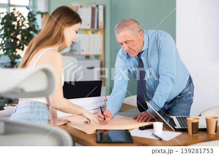 Employees of the construction company make edits to the project 139281753