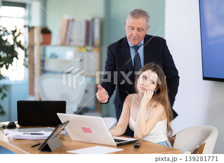 Mature male manager is dissatisfied with the work of an employee - yells and reproaches her 139281771