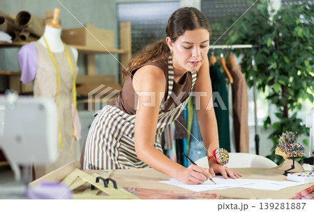 Female seamstress drawing sketches 139281887
