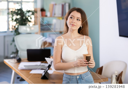 Woman holds a cup of strong coffee in the morning in the office 139281948