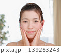 スキンケアで頬に手を当てるナチュラルな日本人女性（美肌・美容） 139283243