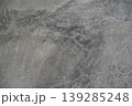 gray weathered concrete wall texture with rough surface and cracks 139285248