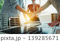 Business team shaking hands over solar panel project plans on a bright office table 139285671