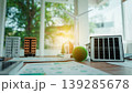 Renewable energy concept on desk with miniature buildings, small wind turbine, solar panel and green model tree, planning documents, bright modern office background. 139285678