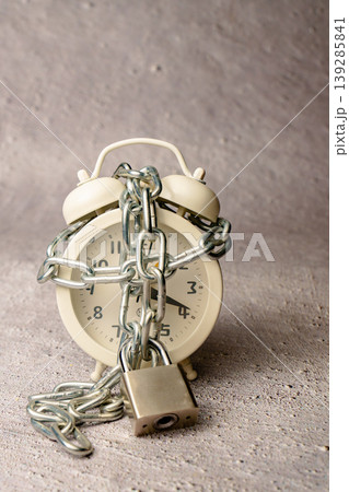 Alarm clock chained and locked, symbolizing limited time Alarm clock chained and locked, symbolizing limited time 139285841