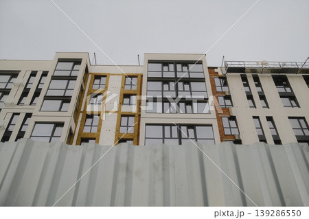 A residential building is being built with insulation visible 139286550