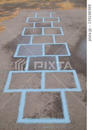 Hopscotch on pavement marked with light blue lines. A classic playground game 139286569