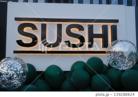 The Sushi sign stands above balloons and spheres, at a grand opening The Sushi sign stands above balloons and spheres, at a grand opening 139286624