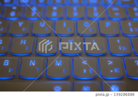 Blue backlit keyboard with English and Cyrillic keys 139286886