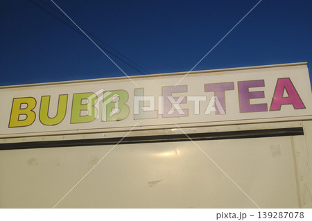 A sign on a white truck advertises Bubble Tea with colorful, bold lettering A sign on a white truck advertises Bubble Tea with colorful, bold lettering 139287078