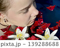 a beautiful girl bathes in a phyto barrel or bath with rose and lily petals 139288688