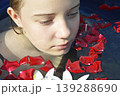 a beautiful girl bathes in a phyto barrel or bath with rose and lily petals 139288690