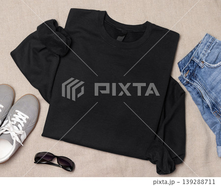 Blank black unisex sweatshirt mockup, folded flat lay with denim shorts and grey sneakers, top view 139288711