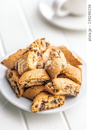 Grissini. Crispy Chocolate Chip Biscotti With Coffee Cup on White Table, Rustic Morning Snack and Dessert Grissini. Crispy Chocolate Chip Biscotti With Coffee Cup on White Table, Rustic Morning Snack and Dessert 139290156