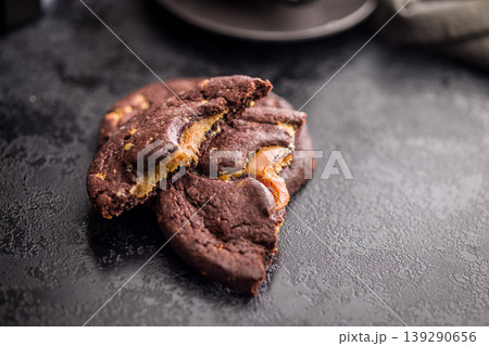 Gooey Caramel Filled Chocolate Cookies Stacked With Coffee Cup Dark Moody Dessert Close-Up 139290656