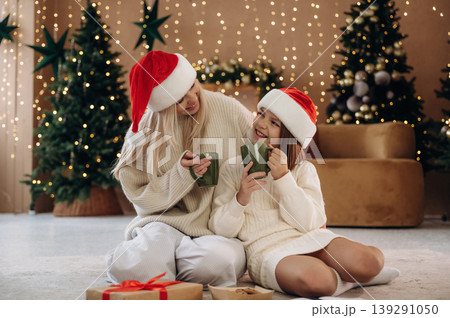 Mother and daughter are celebrating New Year at home in domestic room Mother and daughter are celebrating New Year at home in domestic room 139291050