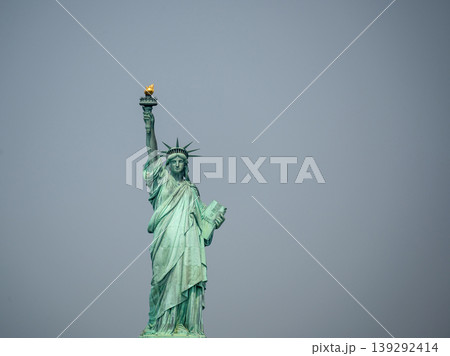 New york, usa august 16,2024. Statue of liberty on liberty island under an overcast sky, iconic symbol of freedom, democracy and welcome in the usa 139292414