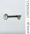 Top view of a single vintage metal key isolated on a white background. 139292621