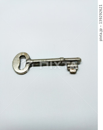 Top view of a single vintage metal key isolated on a white background. Top view of a single vintage metal key isolated on a white background. 139292621