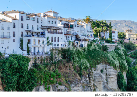 The picturesque town of Ronda in Spain is located on a cliff. The picturesque town of Ronda in Spain is located on a cliff. 139292787