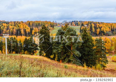 Ski resort landscape showcasing beautiful autumn foliage and ski lifts in the distance Ski resort landscape showcasing beautiful autumn foliage and ski lifts in the distance 139292901