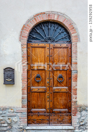 Antique wooden door in an old stone wall of a house Antique wooden door in an old stone wall of a house 139292958
