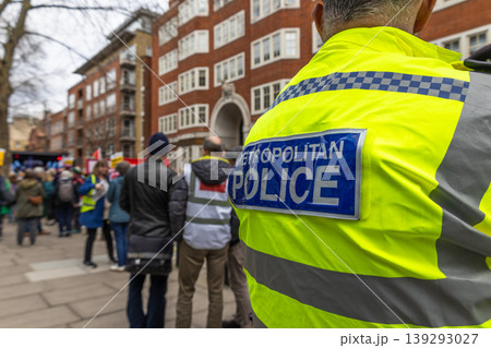 Metropolitan police officer monitoring a public protest in London Metropolitan police officer monitoring a public protest in London 139293027