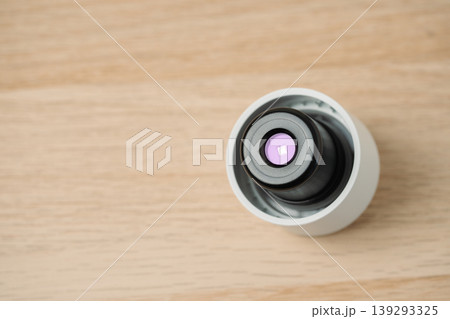 Close-up view of a water bottle cap with UV light mounted on a light wooden surface, highlighting precision water cleaning, reusable health technology and creative projects. Close-up view of a water bottle cap with UV light mounted on a light wooden surface, highlighting precision water cleaning, reusable health technology and creative projects. 139293325