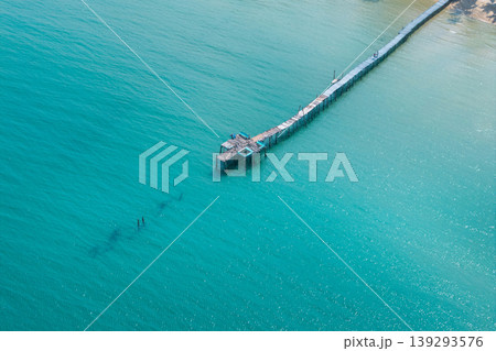 Long wooden pier stretching into the turquoise ocean at a luxury resort, Eastern Sea of Thailand. Long wooden pier stretching into the turquoise ocean at a luxury resort, Eastern Sea of Thailand. 139293576