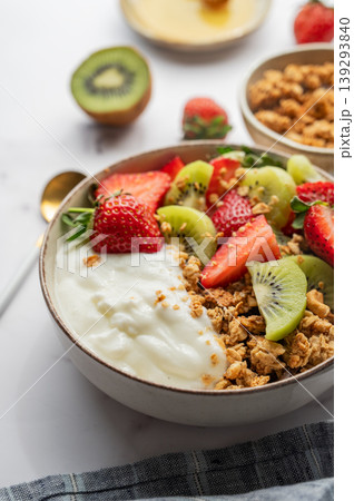 Balanced breakfast with yogurt, granola and fruits close up Balanced breakfast with yogurt, granola and fruits close up 139293840