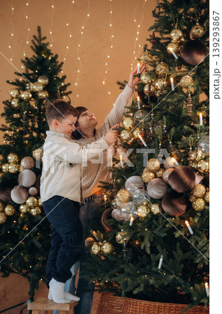 Sister and brother are decorating Christmas tree at home together Sister and brother are decorating Christmas tree at home together 139293867
