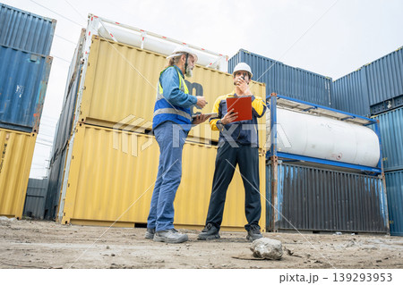 Engineers Inspect Cargo Shipment at Container Yard, Logistics Concept. Engineers Inspect Cargo Shipment at Container Yard, Logistics Concept. 139293953